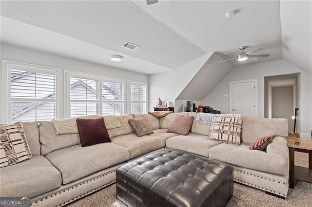 carpeted living room with ceiling fan and lofted ceiling