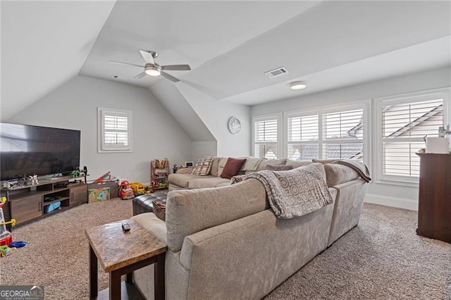 living room featuring ceiling fan, carpet floors, and vaulted ceiling