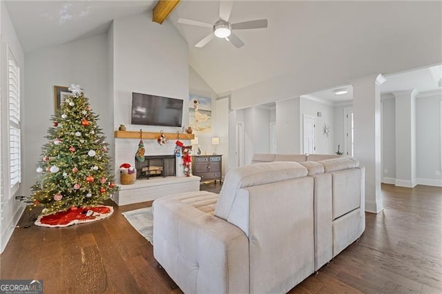 living room featuring vaulted ceiling with beams, dark hardwood / wood-style floors, and ceiling fan