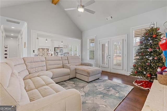 living room featuring french doors, dark hardwood / wood-style flooring, ceiling fan, beam ceiling, and high vaulted ceiling