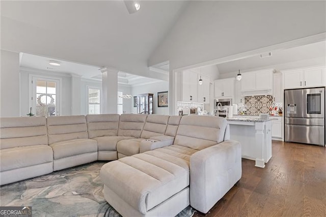 living room featuring dark hardwood / wood-style flooring and high vaulted ceiling