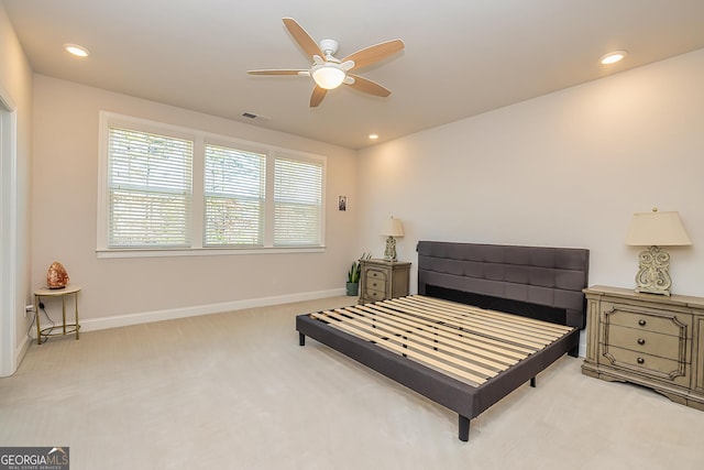 bedroom with light carpet and ceiling fan