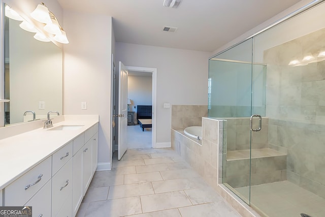 bathroom featuring tile patterned flooring, vanity, and independent shower and bath