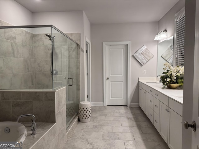 bathroom with vanity and separate shower and tub