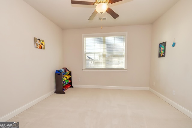 playroom with light carpet and ceiling fan