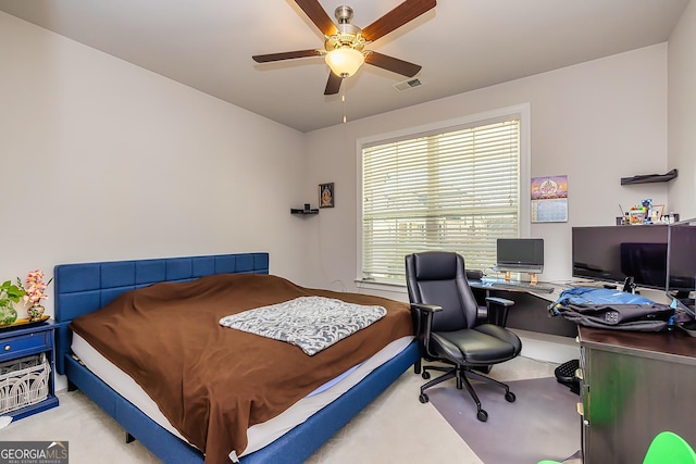 bedroom with ceiling fan and light colored carpet