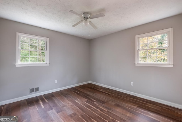 unfurnished room featuring ceiling fan, dark hardwood / wood-style flooring, and a textured ceiling