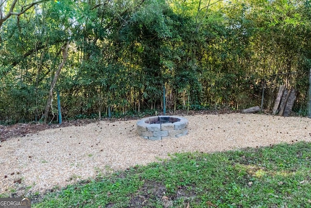 view of yard with a fire pit