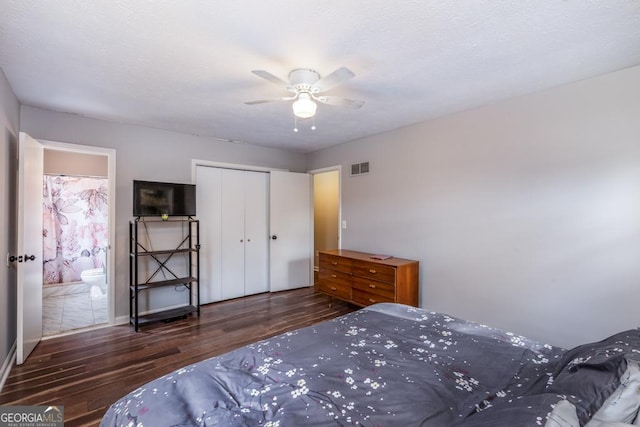 bedroom featuring ceiling fan, dark hardwood / wood-style flooring, ensuite bathroom, and a closet