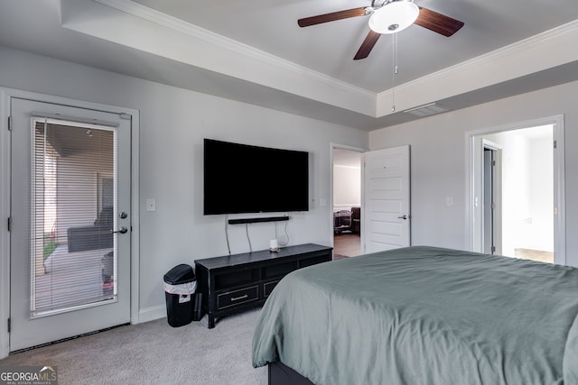 bedroom featuring light carpet, ornamental molding, a raised ceiling, and ceiling fan