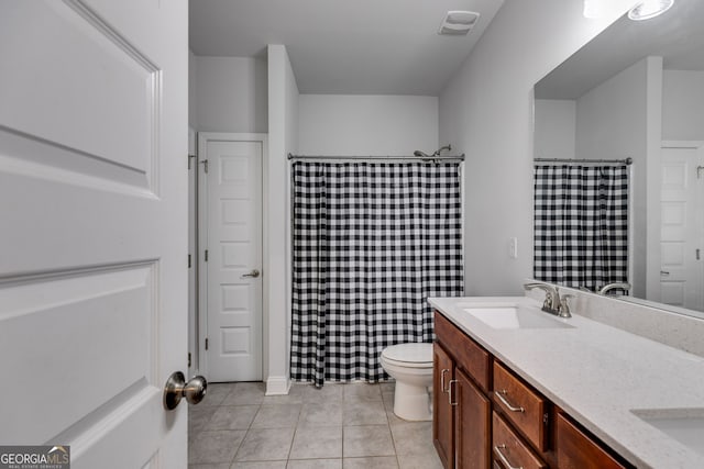 bathroom with vanity, tile patterned floors, and toilet