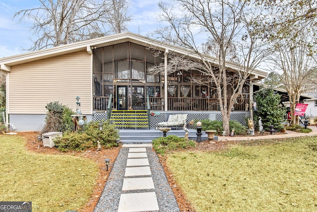 exterior space featuring a sunroom and a yard