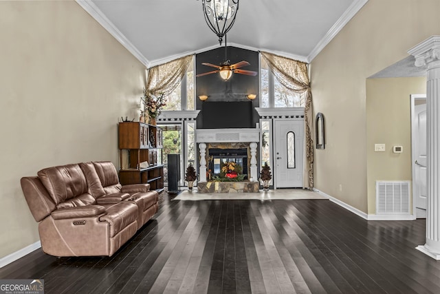 living room with dark hardwood / wood-style floors, crown molding, and a wealth of natural light