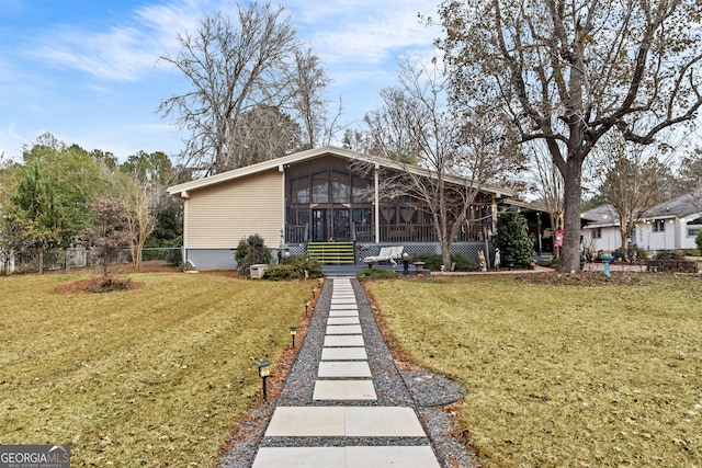 exterior space with a yard and a sunroom