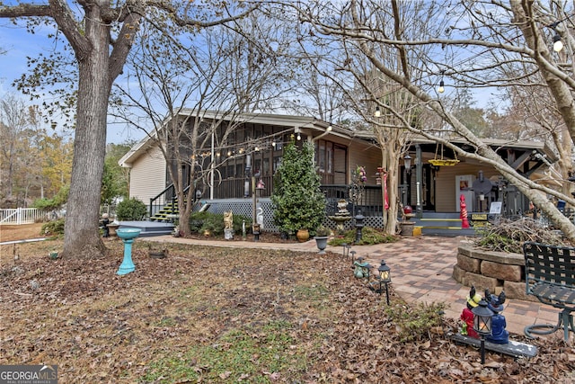 view of front of property featuring a patio area and a sunroom