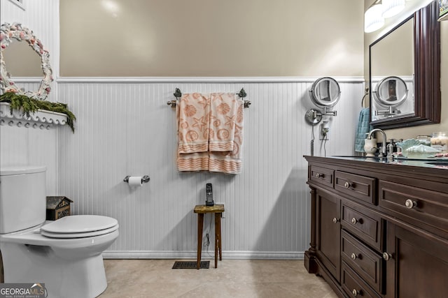 bathroom featuring tile patterned floors, vanity, and toilet