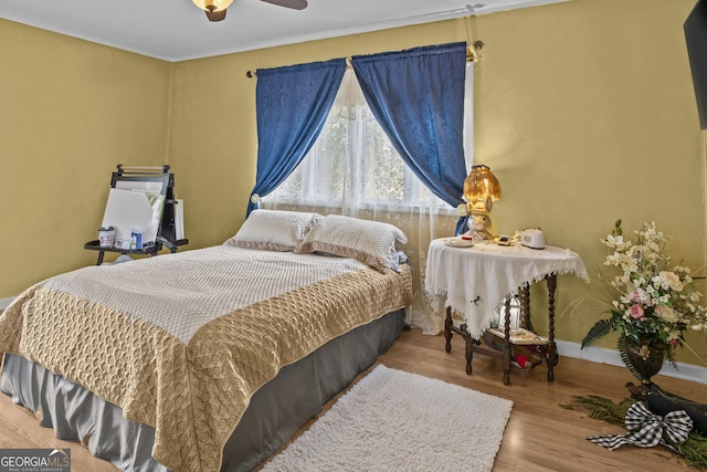 bedroom with light hardwood / wood-style floors and ceiling fan