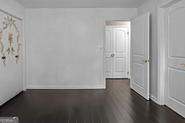 empty room featuring dark hardwood / wood-style flooring