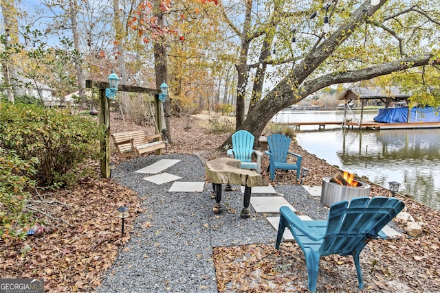 view of yard featuring a water view and a dock