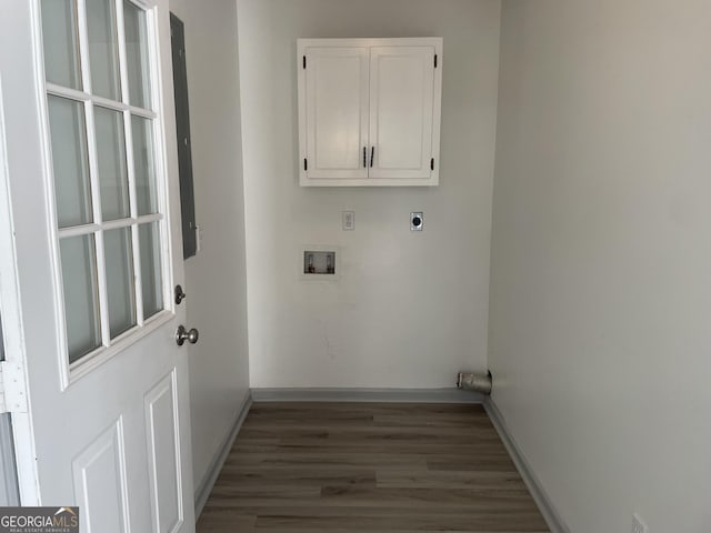 clothes washing area featuring dark wood-type flooring, cabinets, hookup for a washing machine, and hookup for an electric dryer