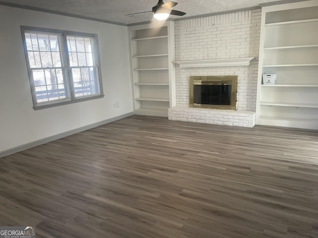 unfurnished living room featuring a textured ceiling, ceiling fan, a fireplace, and dark wood-type flooring