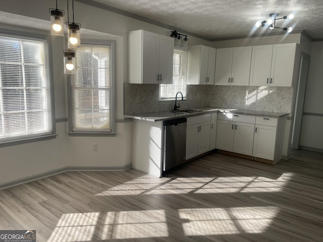 kitchen with light stone countertops, white cabinets, decorative light fixtures, hardwood / wood-style flooring, and stainless steel dishwasher