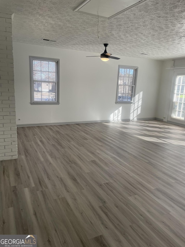 interior space featuring a textured ceiling, ceiling fan, and hardwood / wood-style flooring