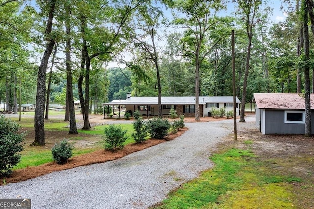 ranch-style house with an outdoor structure and a carport