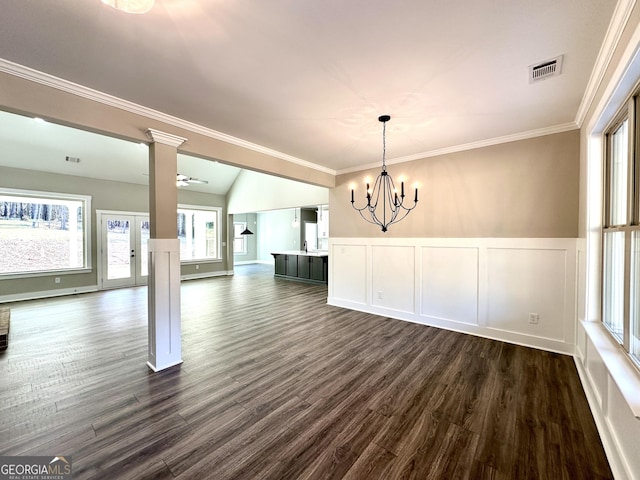 unfurnished dining area featuring crown molding, dark wood finished floors, visible vents, and decorative columns