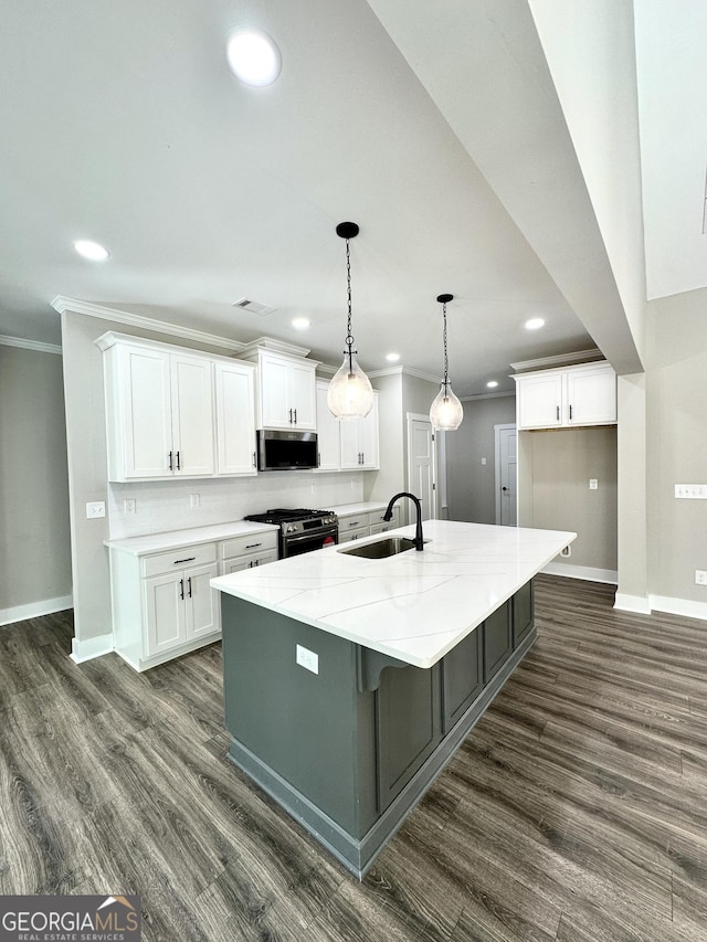 kitchen featuring dark wood-style floors, white cabinetry, stainless steel appliances, and a sink