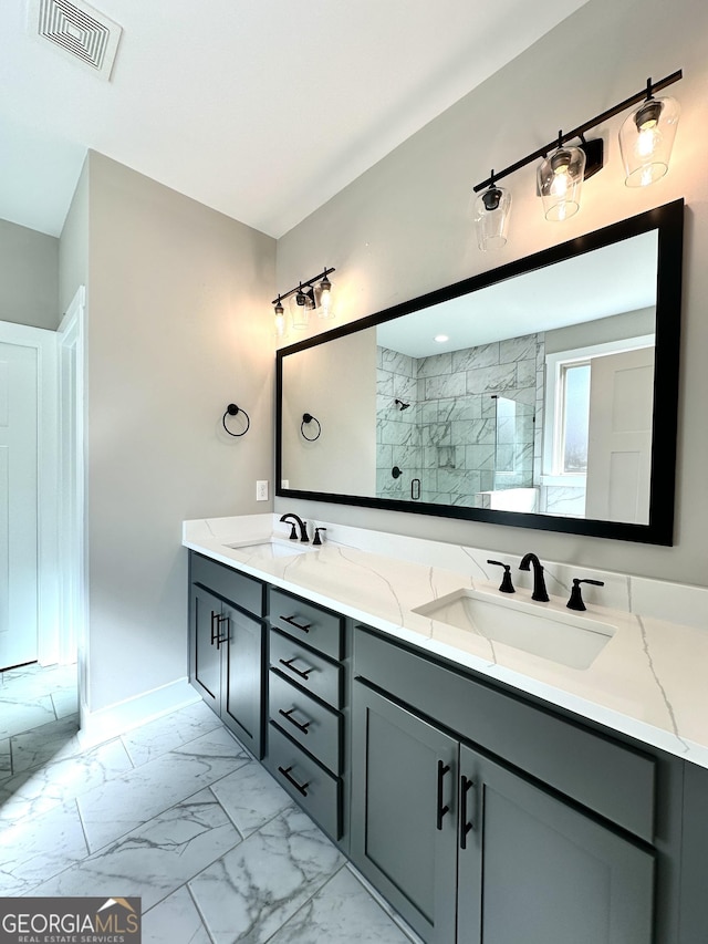 full bath with marble finish floor, a stall shower, a sink, and visible vents