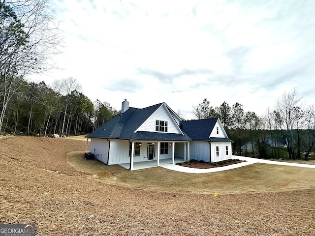 view of front of property featuring roof with shingles and a chimney