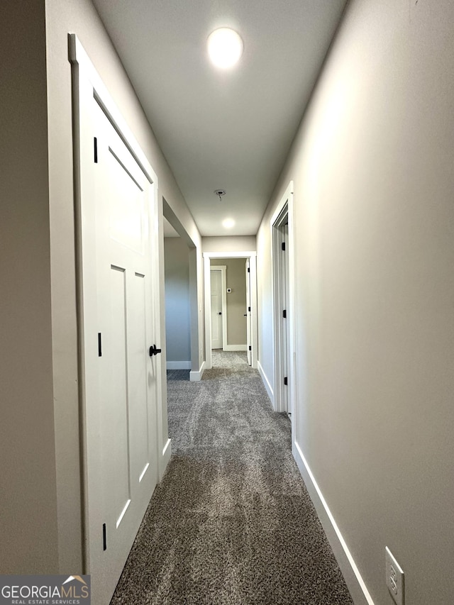 hall with carpet and baseboards