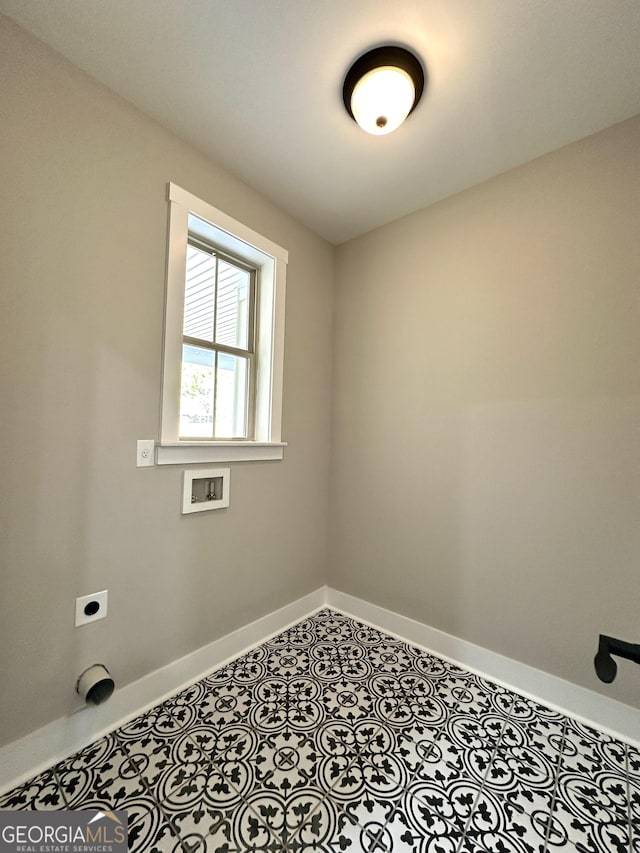 clothes washing area featuring laundry area, baseboards, tile patterned floors, hookup for a washing machine, and electric dryer hookup