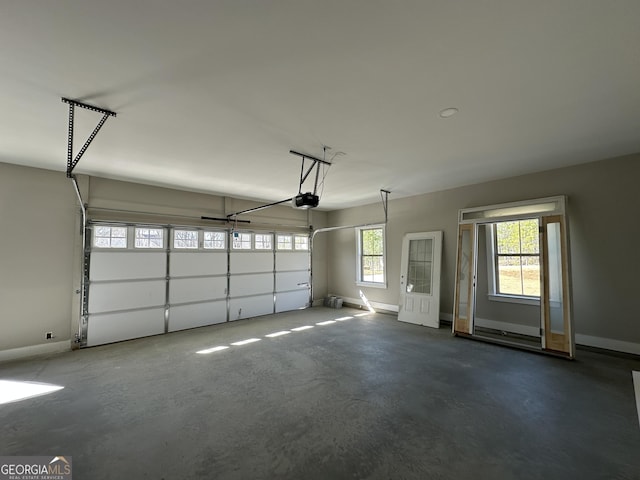 garage with a garage door opener and baseboards