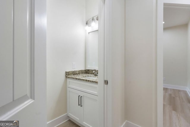 bathroom with vanity and wood-type flooring