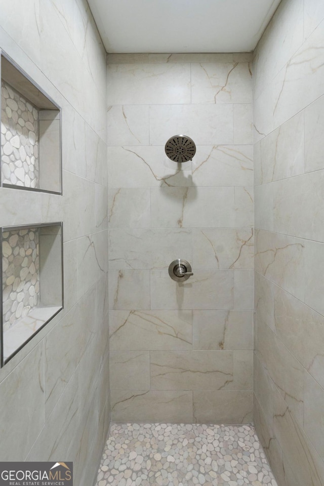 bathroom with tiled shower