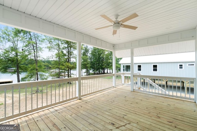 wooden terrace with ceiling fan and a water view