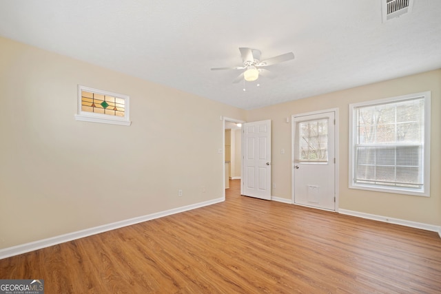 unfurnished room with ceiling fan and light hardwood / wood-style floors