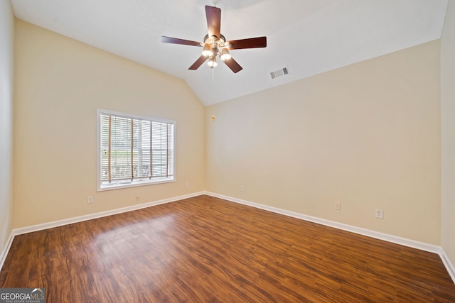 empty room with dark hardwood / wood-style flooring, ceiling fan, and lofted ceiling