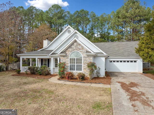 view of front of house with a front lawn, a porch, and a garage