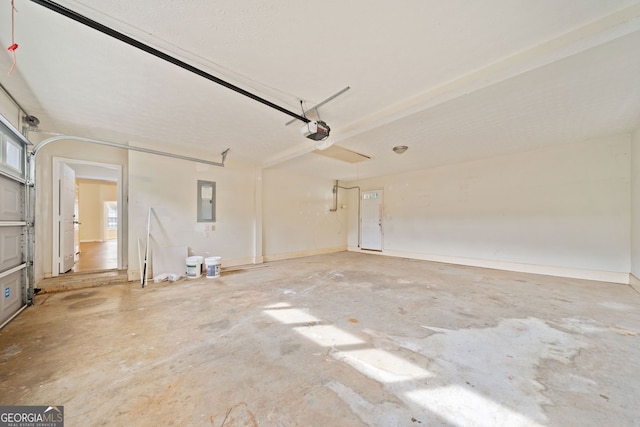 garage with electric panel and a garage door opener