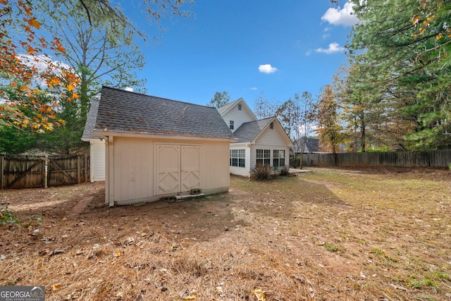 back of property featuring a shed