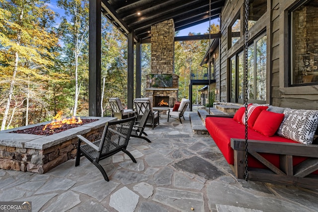 view of patio featuring an outdoor living space with a fireplace