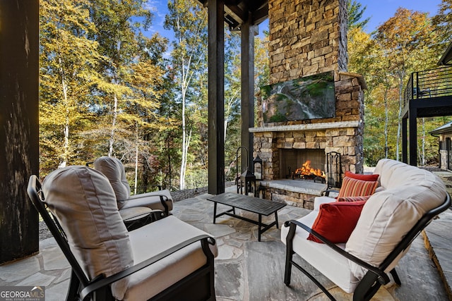 view of patio / terrace with an outdoor living space with a fireplace