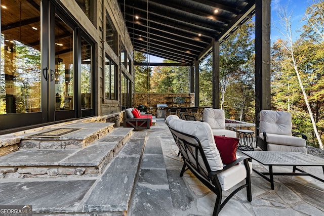 view of patio with french doors and exterior kitchen