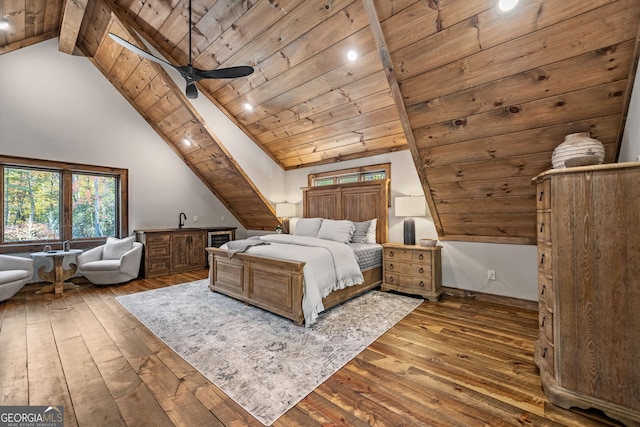 unfurnished bedroom featuring hardwood / wood-style floors, beamed ceiling, wood ceiling, and sink