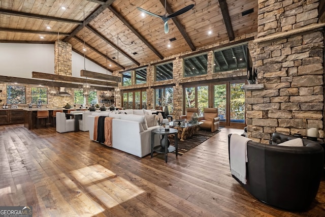 unfurnished living room with wood ceiling, ceiling fan, hardwood / wood-style flooring, high vaulted ceiling, and beamed ceiling