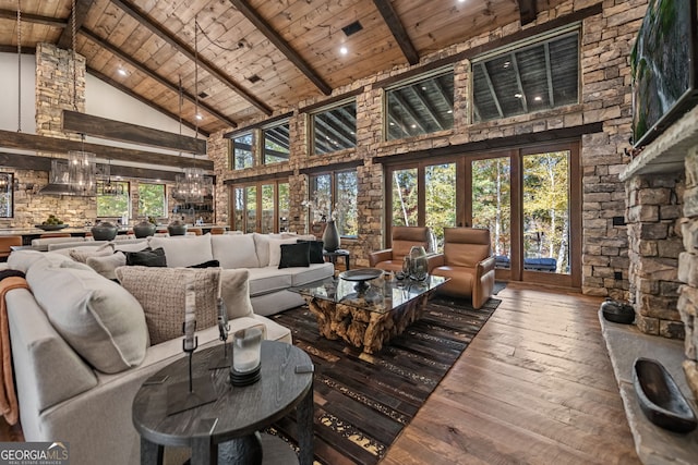 interior space with vaulted ceiling with beams, wood ceiling, and a chandelier