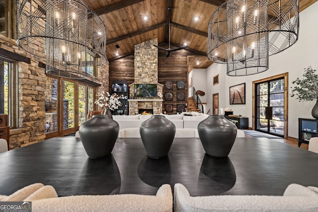 playroom featuring wooden ceiling, an inviting chandelier, high vaulted ceiling, a fireplace, and hardwood / wood-style flooring